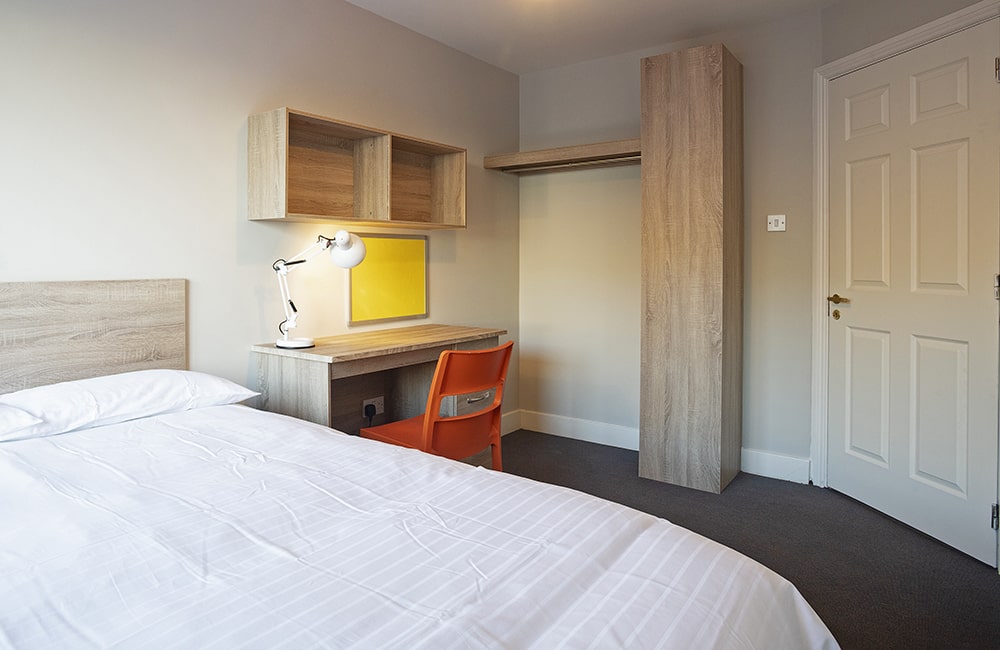 Radical Student Accommodation Galway Deluxe Double En-Suite Apartment double bed study desk and shelves